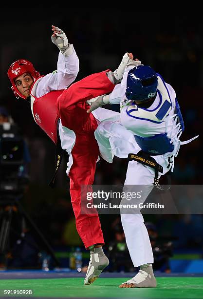 Alexey Denisenko of Russia competes against Ahmad Abughaush of Jordan during the men's -68kg Gold Medal Taekwondo contest at the Carioca Arena on Day...