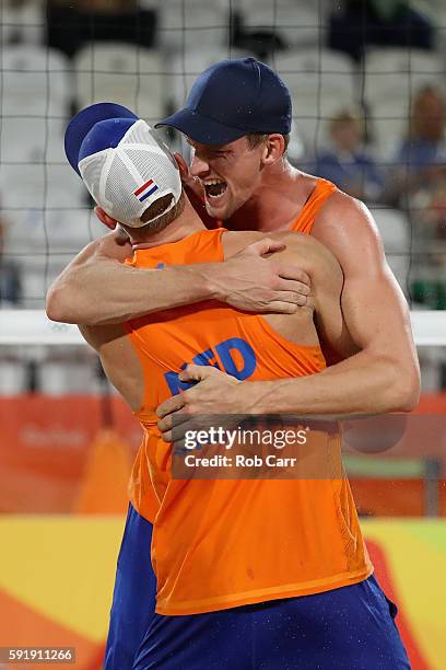 Alexander Brouwer and Robert Meeuwsen of Netherlands celebrate winning the Men's Beach Volleyball Bronze medal match against Viacheslav Krasilnikov...