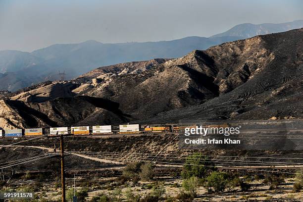 Freight train travel through charred Cajon Pass on Thursday morning.