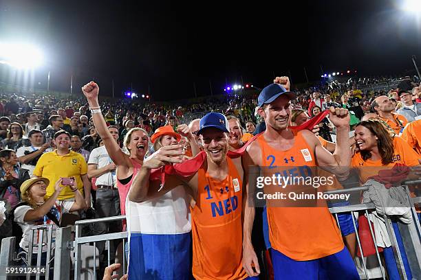 Alexander Brouwer and Robert Meeuwsen of Netherlands celebrate with fans winning the Men's Beach Volleyball Bronze medal match against Viacheslav...