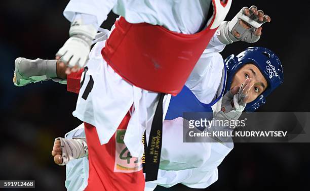 Russia's Alexey Denisenko competes against Jordan's Ahmad Abughaush during the men's taekwondo gold medal bout in the -68kg category as part of the...