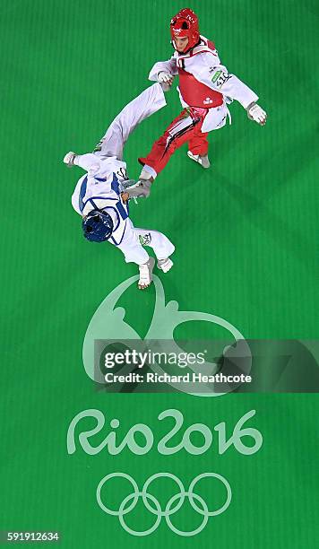 Alexey Denisenko of Russia competes against Ahmad Abughaush of Jordan during the men's -68kg Gold Medal Taekwondo contest at the Carioca Arena on Day...