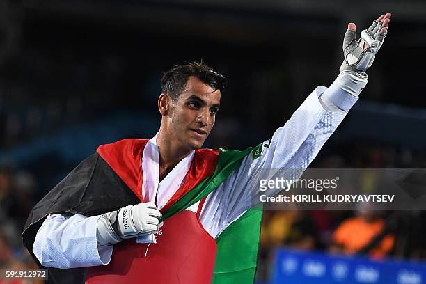 Jordan's Ahmad Abughaush celebrates after winning against Russia's Alexey Denisenko in the men's taekwondo gold medal bout in the -68kg category as...