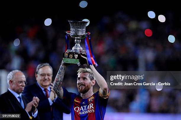 The F.C.Barcelona captain, Lionel Messi, showing the Champions cup, during the F.C.Barcelona vs Sevilla F.C., Spanish Super Cup match, at Nou Camp,...