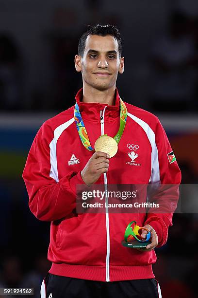 Gold medalist, Ahmad Abughaush of Jordan celebrates on the podium after the men's -68kg Gold Medal Taekwondo contest at the Carioca Arena on Day 13...