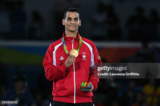 Gold medalist, Ahmad Abughaush of Jordan celebrates on the podium after the men's -68kg Gold Medal Taekwondo contest at the Carioca Arena on Day 13...