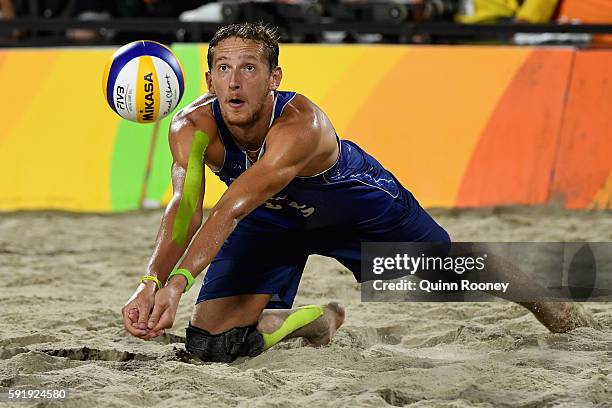 Konstantin Semenov of Russia bumbs the ball during the Men's Beach Volleyball Bronze medal match against Alexander Brouwer and Robert Meeuwsen of...