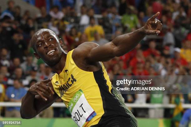 Jamaica's Usain Bolt does his "Lightening Bolt" pose after he won the Men's 200m Final during the athletics event at the Rio 2016 Olympic Games at...