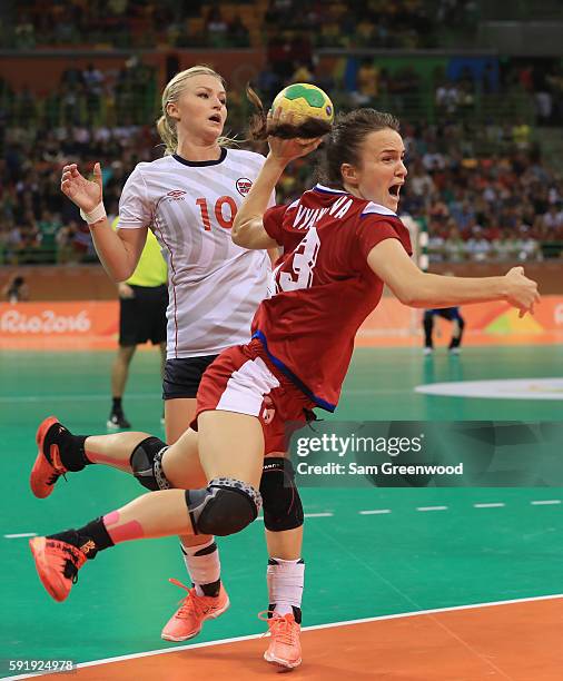 Anna Vyakhireva of Russia runs past Stine Bredal Oftedal of Norway for an attempted shot during the Women's Handball Semi-final match at the Future...