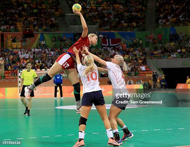 Stine Bredal Oftedal and Veronica Kristiansen of Norway attempt to stop Vladlena Bobrovnikova of Russia during the Women's Handball Semi-final match...