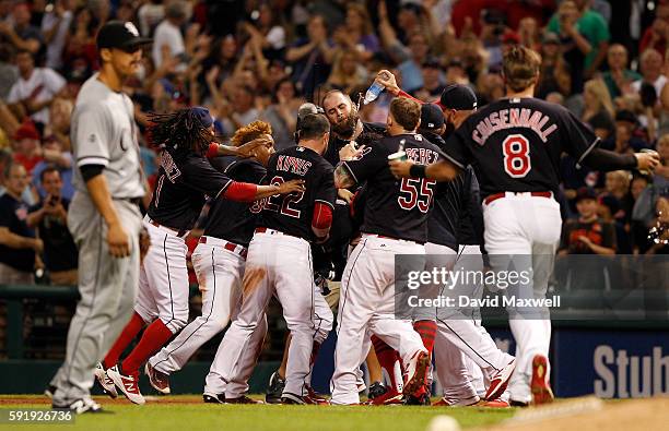 Teammates mob Tyler Naquin of the Cleveland Indians after he hit a game winning sacrifice fly against the Chicago White Sox in the ninth inning at...