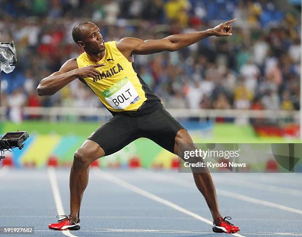 Usain Bolt of Jamaica strikes his signature "Lightning Bolt" pose after winning the men's 200-meter gold medal at the Rio de Janeiro Olympics on Aug....