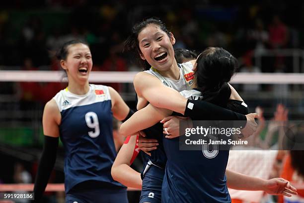 Ting Zhu of China celebrates victory over the Netherlands with her teammates in the Women's Volleyball Semifinal match at the Maracanazinho on Day 13...