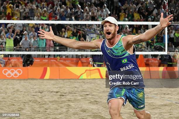 Alison Cerutti of Brazil celebrates winning the Men's Beach Volleyball Gold medal match against Paolo Nicolai and Daniele Lupo of Italy at the Beach...
