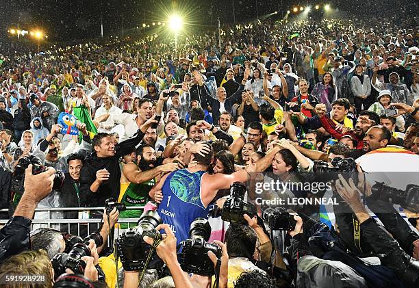 Brazil's Alison Cerutti celebrates after winning the men's beach volleyball final match between Italy and Brazil at the Beach Volley Arena in Rio de...