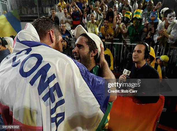 Alison Cerutti and Bruno Schmidt Oscar of Brazil celebrate winning the Men's Beach Volleyball Gold medal match against Paolo Nicolai and Daniele Lupo...