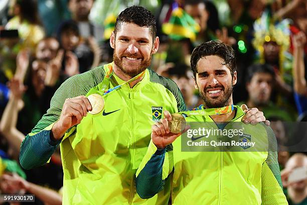 Gold medalists Alison Cerutti and Bruno Schmidt Oscar of Brazil stand on the podium during the medal ceremony for the Men's Beachvolleyball contest...