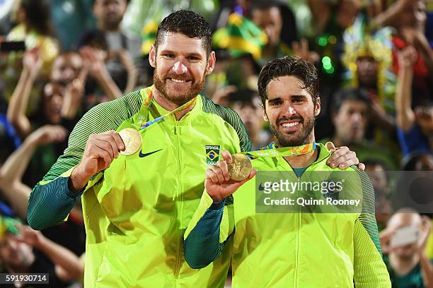 Gold medalists Alison Cerutti and Bruno Schmidt Oscar of Brazil stand on the podium during the medal ceremony for the Men's Beachvolleyball contest...