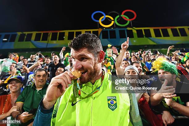 Gold medalist Alison Cerutti of Brazil celebrates following the medal ceremony for the Men's Beachvolleyball contest at the Beach Volleyball Arena on...