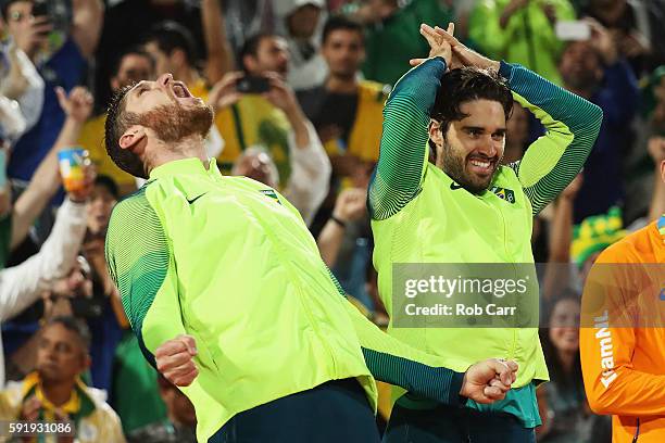 Gold medalists Alison Cerutti and Bruno Schmidt Oscar of Brazil celebrate on the podium during the medal ceremony for the Men's Beachvolleyball...