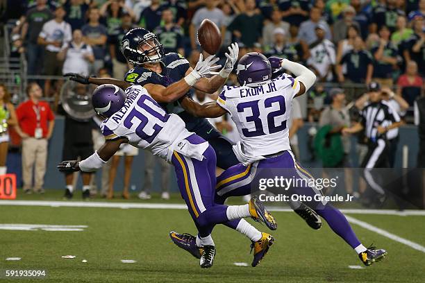 Wide receiver Tanner McEvoy of the Seattle Seahawks fails to catch a pass against cornerback Mackensie Alexander and safety Antone Exum Jr. #32 of...