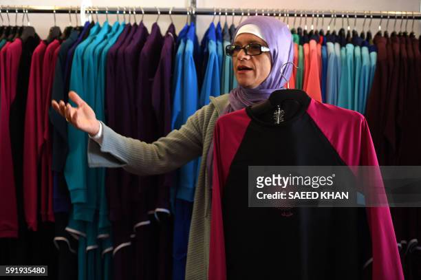Australian-Lebanese designer Aheda Zanetti explains her products of burkini swimsuits at a shop in western Sydney on August 19, 2016. - Part bikini,...