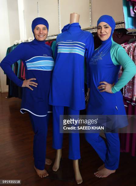 Muslim models display burkini swimsuits at a shop in western Sydney on August 19, 2016. - Part bikini, part all-covering burqa, the burqini swimsuit...
