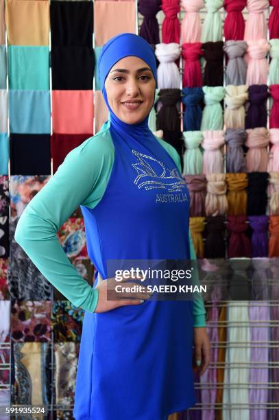 Muslim model display burkini swimsuits at a shop in western Sydney on August 19, 2016. - Part bikini, part all-covering burqa, the burqini swimsuit...