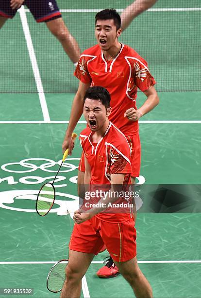 Chai Biao and Hong Wei of China celebrate a point against Ellis Marcus and Langridge Chris of Britain in the Mens Doubles Bronze Medal Match on Day...