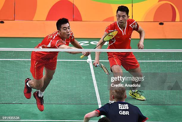 Chai Biao and Hong Wei of China compete against Ellis Marcus and Langridge Chris of Britain in the Mens Doubles Bronze Medal Match on Day 13 of the...