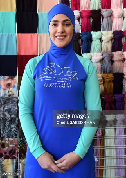 Muslim model display burkini swimsuits at a shop in western Sydney on August 19, 2016. - Part bikini, part all-covering burqa, the burqini swimsuit...