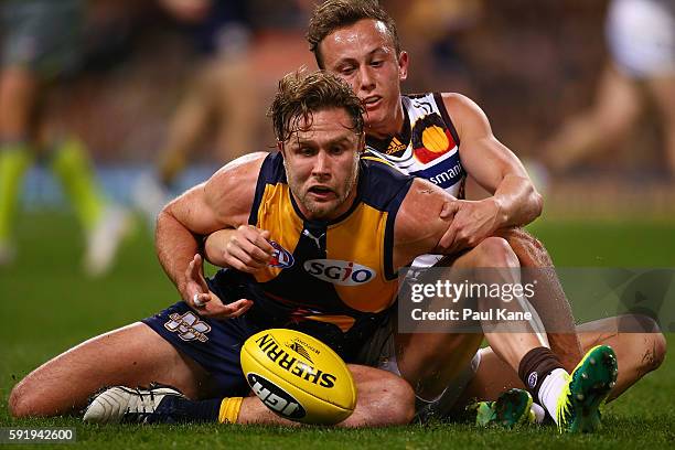 Mark Hutchings of the Eagles gets tackled by Billy Hartung of the Hawks during the round 22 AFL match between the West Coast Eagles and the Hawthorn...