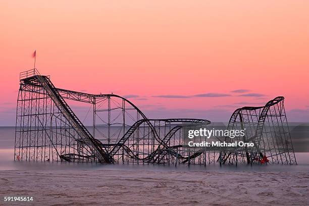 jet star roller coaster in the atlantic ocean from hurricane sandy during sunset. seaside heights, nj - seaside heights fotografías e imágenes de stock