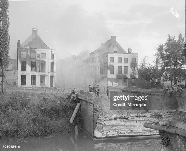 This picture was taken just after the fall of the Belgian town of Lierre, which is 15 miles from Antwerp and shows Royal Marines who having blown up...