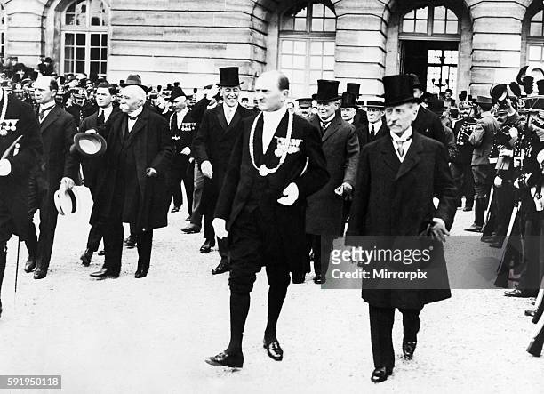 Cheering crowds greet French Premier Georges Clemenceau , American President Woodrow Wilson and British Prime Minister David Lloyd George as the...
