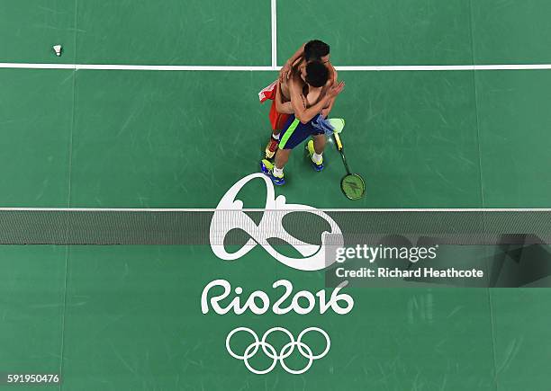 Chong Wei Lee of Malaysia embraces Dan Lin of China after winning the Men's Singles Badminton Semi-final on Day 14 of the Rio 2016 Olympic Games at...