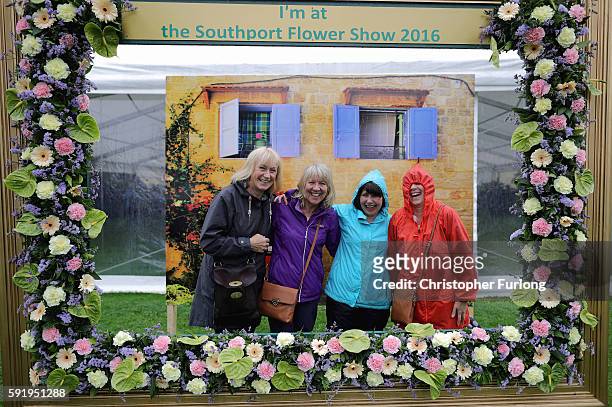 Visitors brave the rain as they tour Southport Flower Show on August 19, 2016 in Southport, England. Friday is traditionally 'Ladies Day' at...