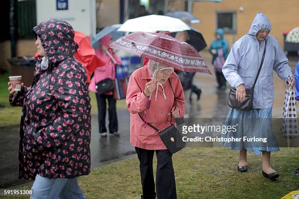 Visitors brave the rain as they tour Southport Flower Show on August 19, 2016 in Southport, England. Friday is traditionally 'Ladies Day' at...
