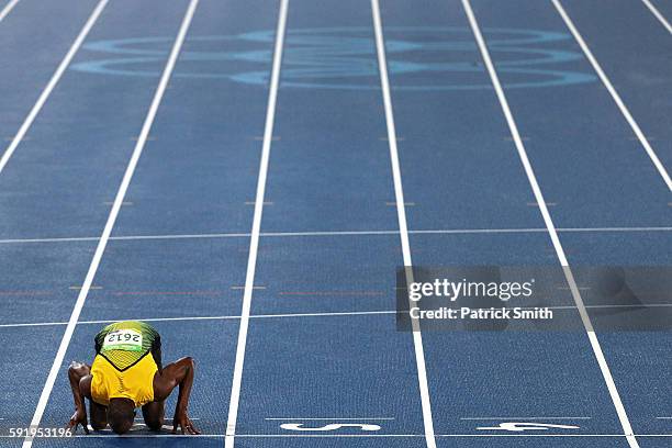 Usain Bolt of Jamaica celebrates winning the Men's 200m Final by kissing the track on Day 13 of the Rio 2016 Olympic Games at the Olympic Stadium on...