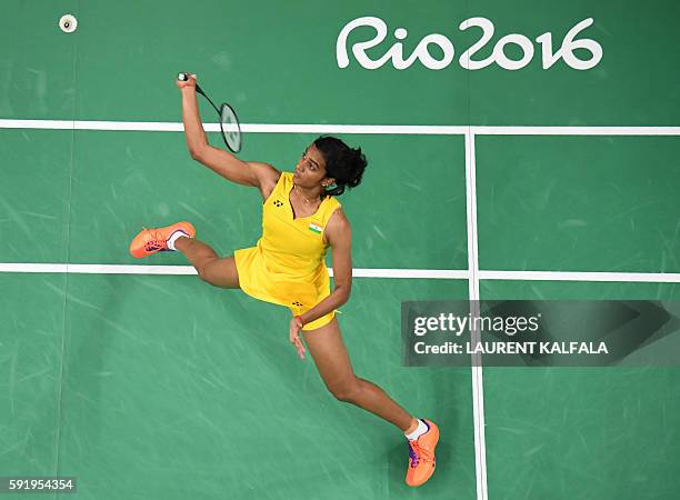 An overview shows India's Pusarla V. Sindhu returns against Spain's Carolina Marin during their women's singles Gold Medal badminton match at the...