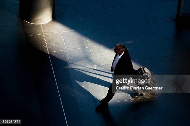 Man with a suitcase goes through the central station on August 19, 2016 in Berlin, Germany.