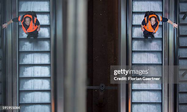 Security person takes the escalator on August 19, 2016 in Berlin, Germany.