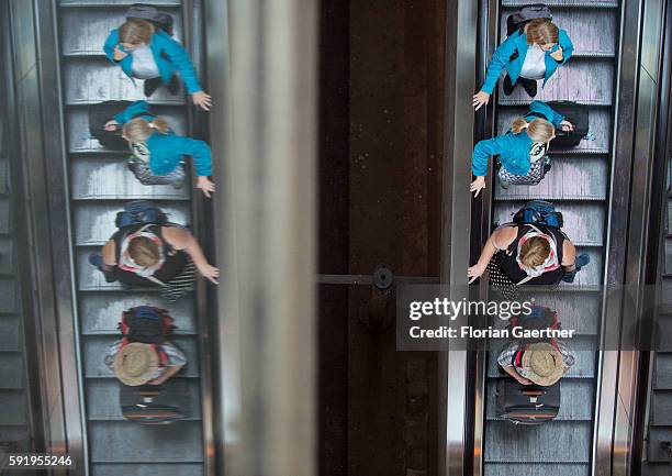 Persons on the escalator are reflected at the central station on August 19, 2016 in Berlin, Germany.