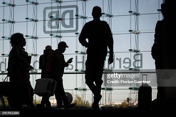Silhouettes of traveler are captured on August 19, 2016 in Berlin, Germany.