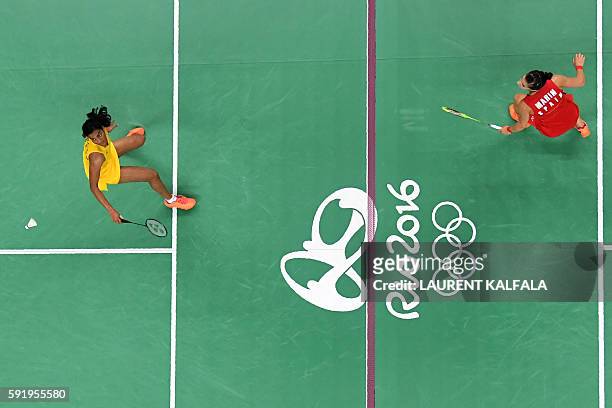 An overview shows Spain's Carolina Marin returns against India's Pusarla V. Sindhu during their women's singles Gold Medal badminton match at the...