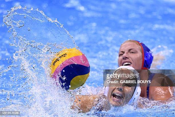 Hungary's Gabriella Szucs vies with Russia's Anna Timofeeva during their Rio 2016 Olympic Games waterpolo Bronze medal match on August 19, 2016 at...