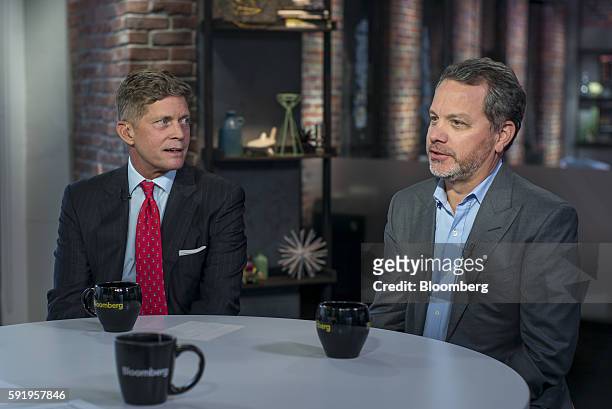 William "Bill" McGlashan, founder and managing partner of TPG Growth LLC, right, speaks as Richard "Bob" Simonds, chief executive officer at STX...