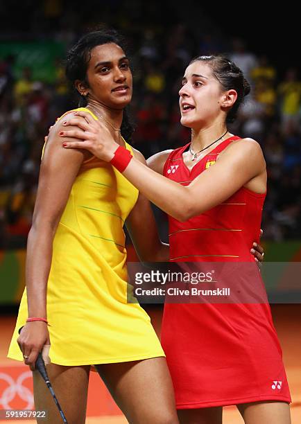 Carolina Marin of Spain embraces V. Sindhu Pusarla of India after winning match point during the Women's Singles Gold Medal Match on Day 14 of the...