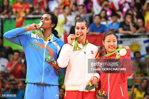 Gold medalist Spain's Carolina Marin , Silver medalist India's Pusarla V. Sindhu and Bronze medalist Japan's Nozomi Okuhara stand with their medals...