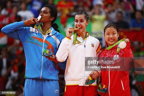 Silver medalist V. Sindhu Pusarla of India, gold medalist Carolina Marin of Spain and bronze medalist Nozomi Okuhara of Japan celebrate during the...